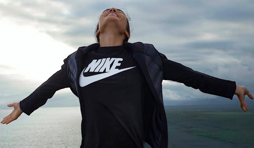 Nike woman wearing Nike top for 25% off sale